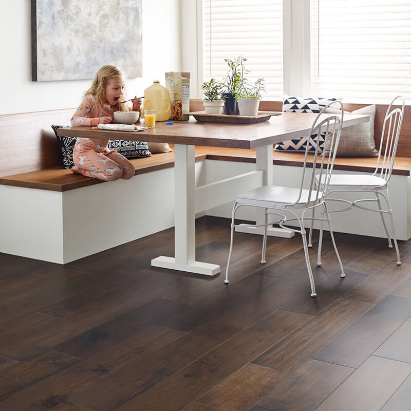 Girl at a kitchen table in a home with waterproof LVP floors