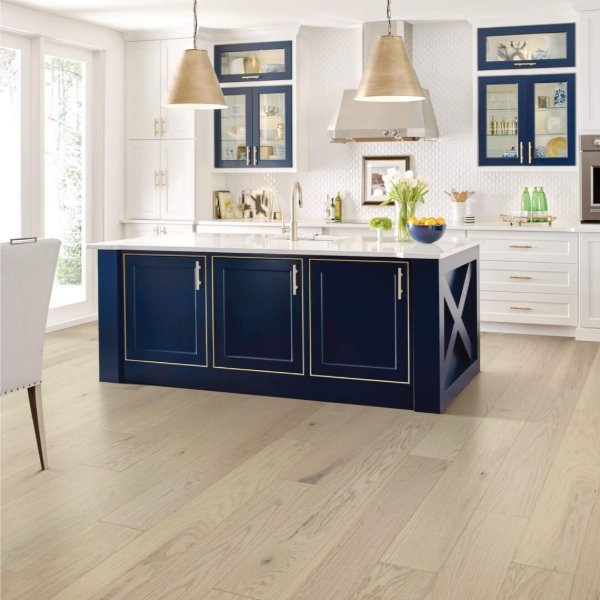 Bright kitchen with wood flooring and royal blue cabinets